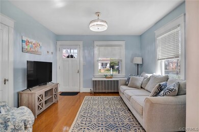 Living room with radiator and light hardwood / woo