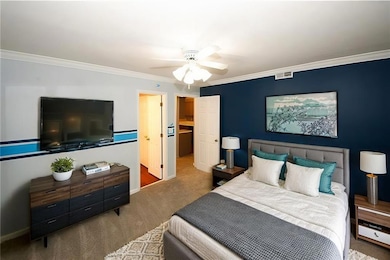 Carpeted bedroom with baseboards, visible vents, c