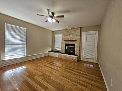 Unfurnished living room featuring a ceiling fan, 