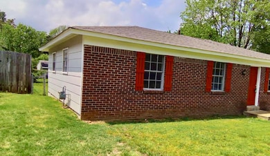 View of side of property featuring brick siding