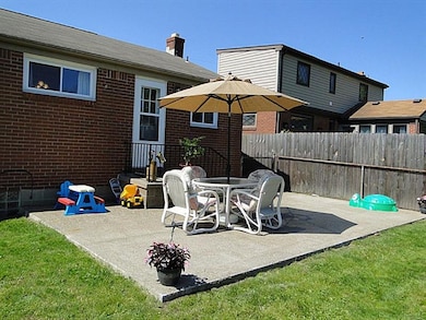 Door from kitchen leads to patio for easy entertai