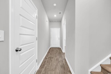 Hall featuring wood finished floors and stairs