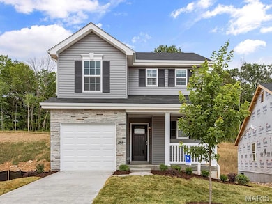 View of front of house featuring a porch, a garage, and a front yard