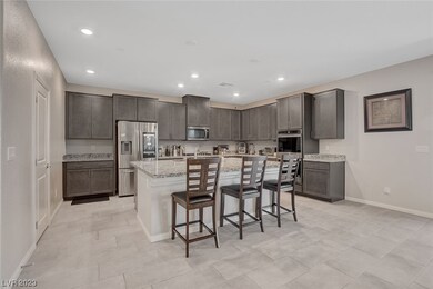 Grey Cabinets line the walls with an oversized isl