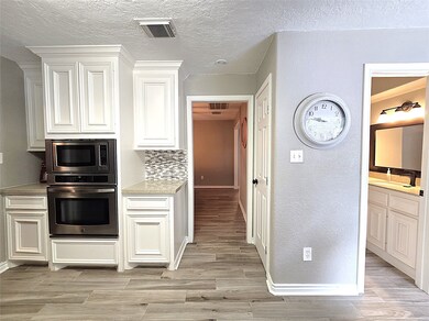 Modern kitchen with sleek cabinetry, convenient ha
