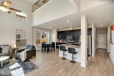 Living room featuring a healthy amount of sunlight, light hardwood / wood-style floors, and ceiling fan
