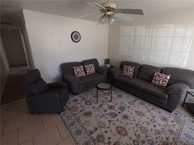Living area with light tile patterned floors, visi