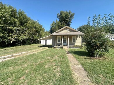 View of front of home with covered porch and a fro