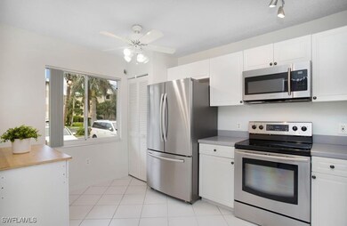 Kitchen with light tile patterned floors, a ceilin