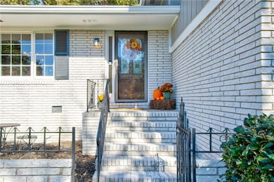 View of exterior entry featuring brick siding