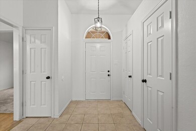 Foyer entrance featuring light colored carpet