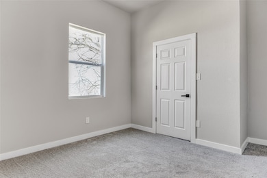 Unfurnished room with light colored carpet