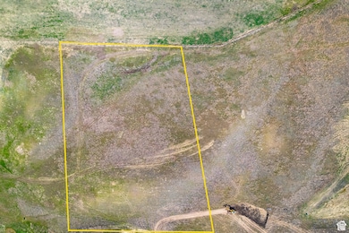 Aerial view of sparsely populated area featuring property boundaries highlighted