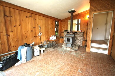 Game Room has Knotty Pine Walls & Wood Burner.