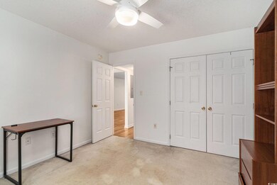 Unfurnished bedroom featuring light carpet, baseboards, a closet, and ceiling fan