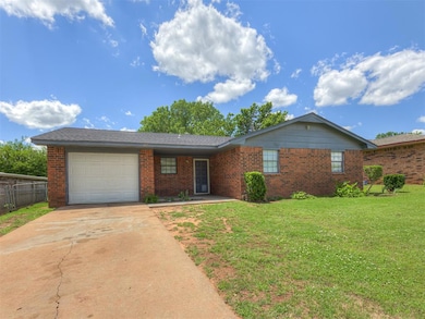 Single story home with brick siding, an attached garage, and driveway