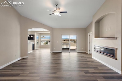 Unfurnished living room featuring vaulted ceiling,