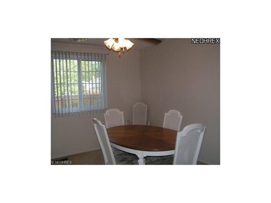 Large dining room with ceiling fan and light. No w