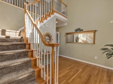 You enter the home to a two story sunny foyer with