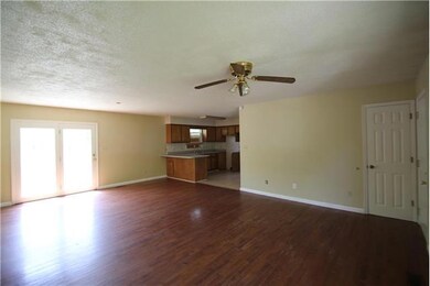 Step in to the open living and dining area with hard wood flooring.