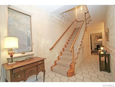 Entrance hall features a Palladian window in the stairwell, elevator, powder room, guest closet, storage closet and access to living room and kitchen.