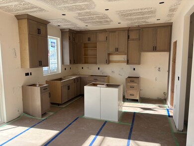Kitchen featuring a center island and brown cabinets