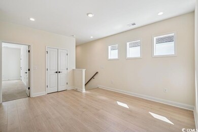 Below grade area featuring light wood-style floors and recessed lighting
