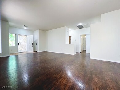 Unfurnished living room featuring wood finished fl