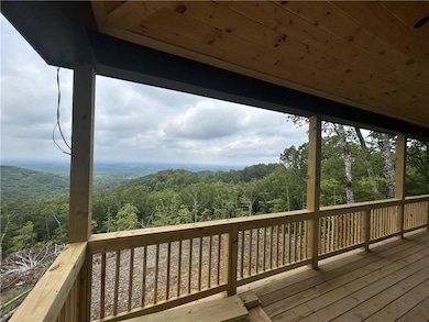 Wooden deck featuring a forest view