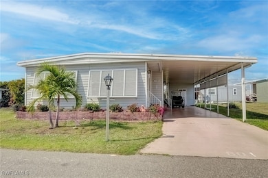 Manufactured / mobile home featuring a carport and