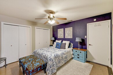Bedroom with two closets and a ceiling fan