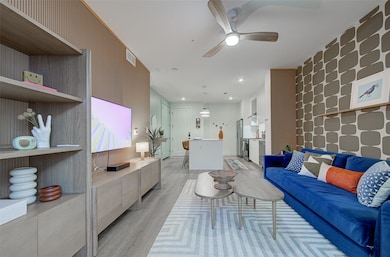 Living area with light wood finished floors, ceil