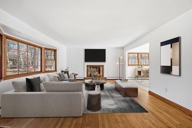 Beautiful Living room with fireplace, hardwood floors with large picture window.