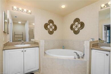 Full bath with two vanities and a bath