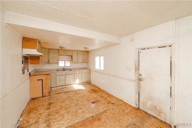 Kitchen featuring visible vents, a sink, under cab