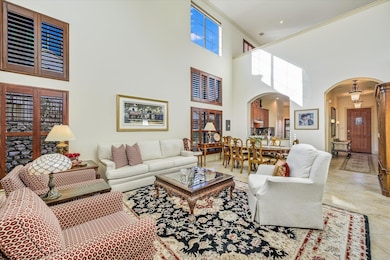 Living area with arched walkways and a high ceili