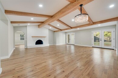 Unfurnished living room featuring french doors, ar