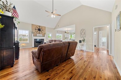 Living area with a fireplace, ceiling fan, high va
