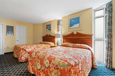 Carpeted bedroom featuring a textured ceiling and 