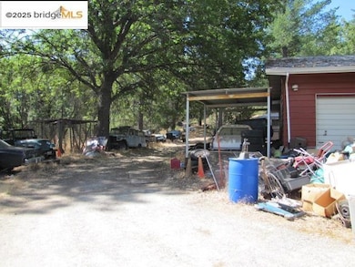 View of yard featuring a carport and a garage