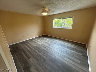 Spare room with ceiling fan, dark wood finished fl