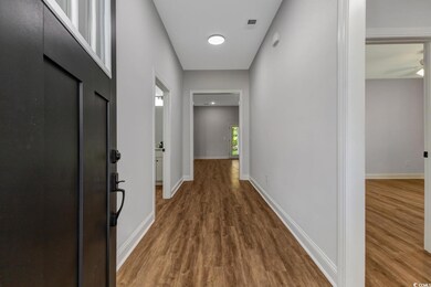 Foyer/entryway with LVP finished floors and baseboards