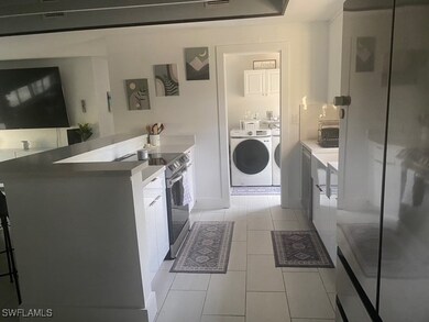 Kitchen with freestanding refrigerator, washing ma