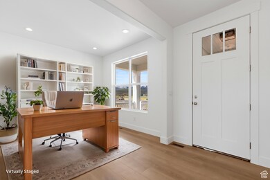 Office area with light wood-type flooring, baseboards, and recessed lighting