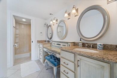 Full bath with vanity, tile patterned floors, a tile shower, baseboards, and recessed lighting