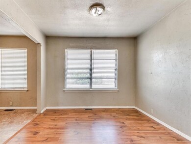 Unfurnished room featuring baseboards, wood finish