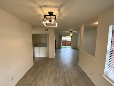 Corridor featuring independent washer and dryer, a