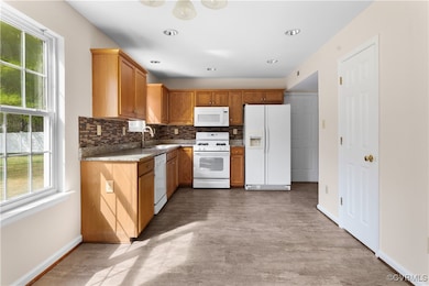 Kitchen featuring tasteful backsplash, baseboards,