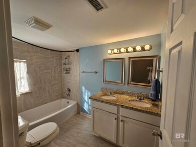 tiled shower / bath combo, toilet, vanity.