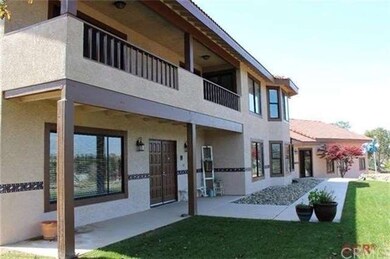 The front entrance with master balcony above
